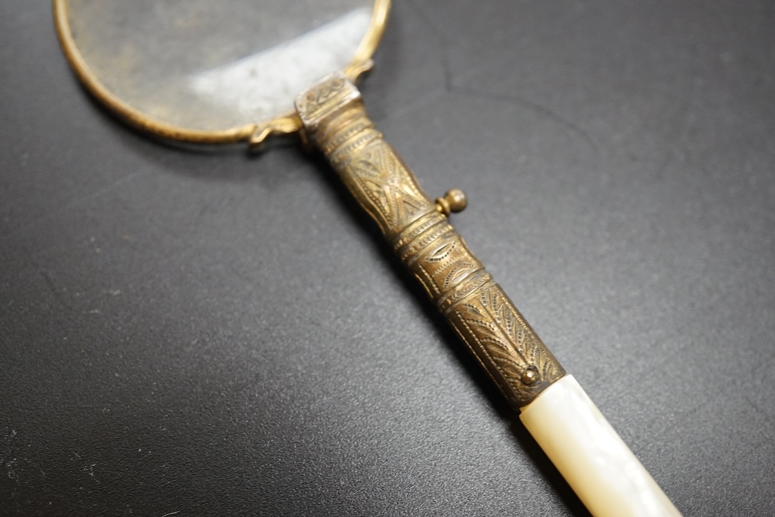 A pair of mother of pearl handled gilt metal lorgnettes in a leather case and a comb housed in an antimony case, largest 16cm in length